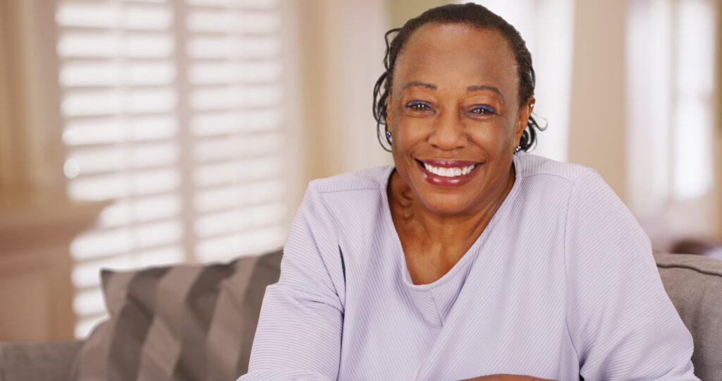 older woman smiling in living room