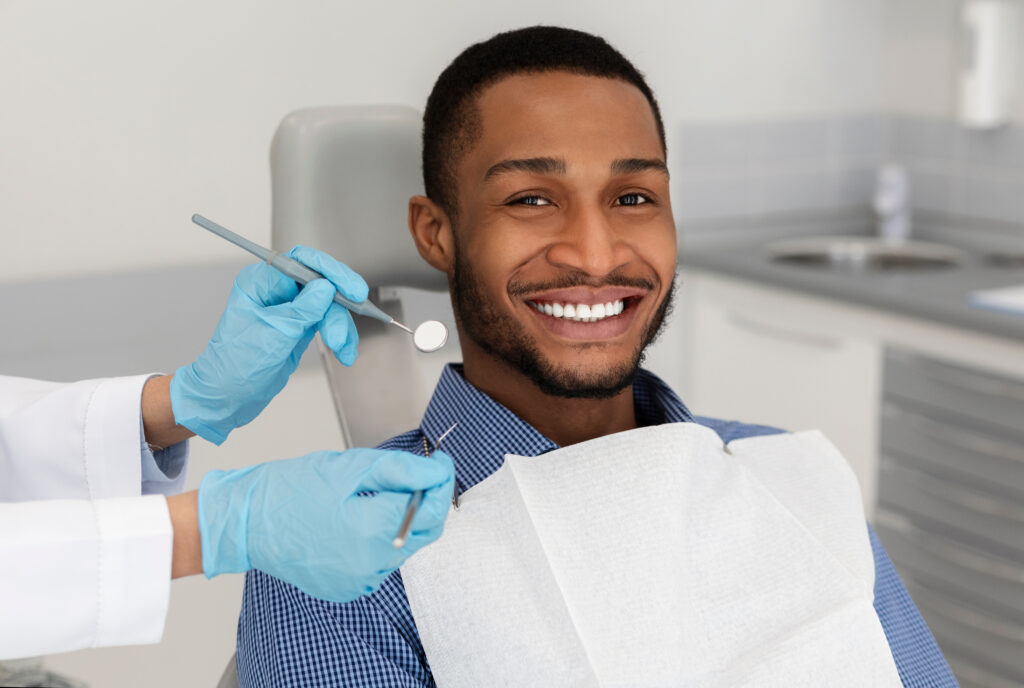 man in dentist chair smiling